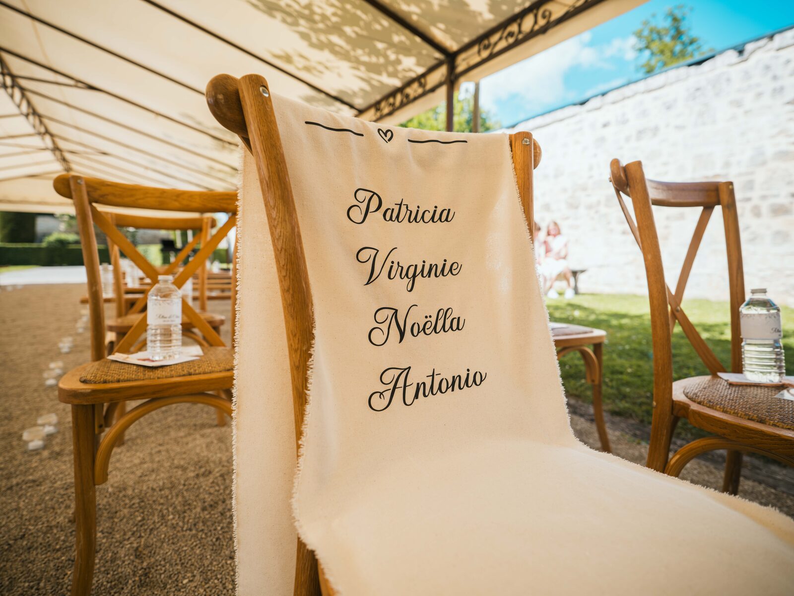 La chaise du souvenir fleurie portant les prénoms des proches disparus, installée pour la cérémonie — mariage au Domaine du Bois Saint Mard, par Jean-Baptiste Argyre (Jaysphotography)