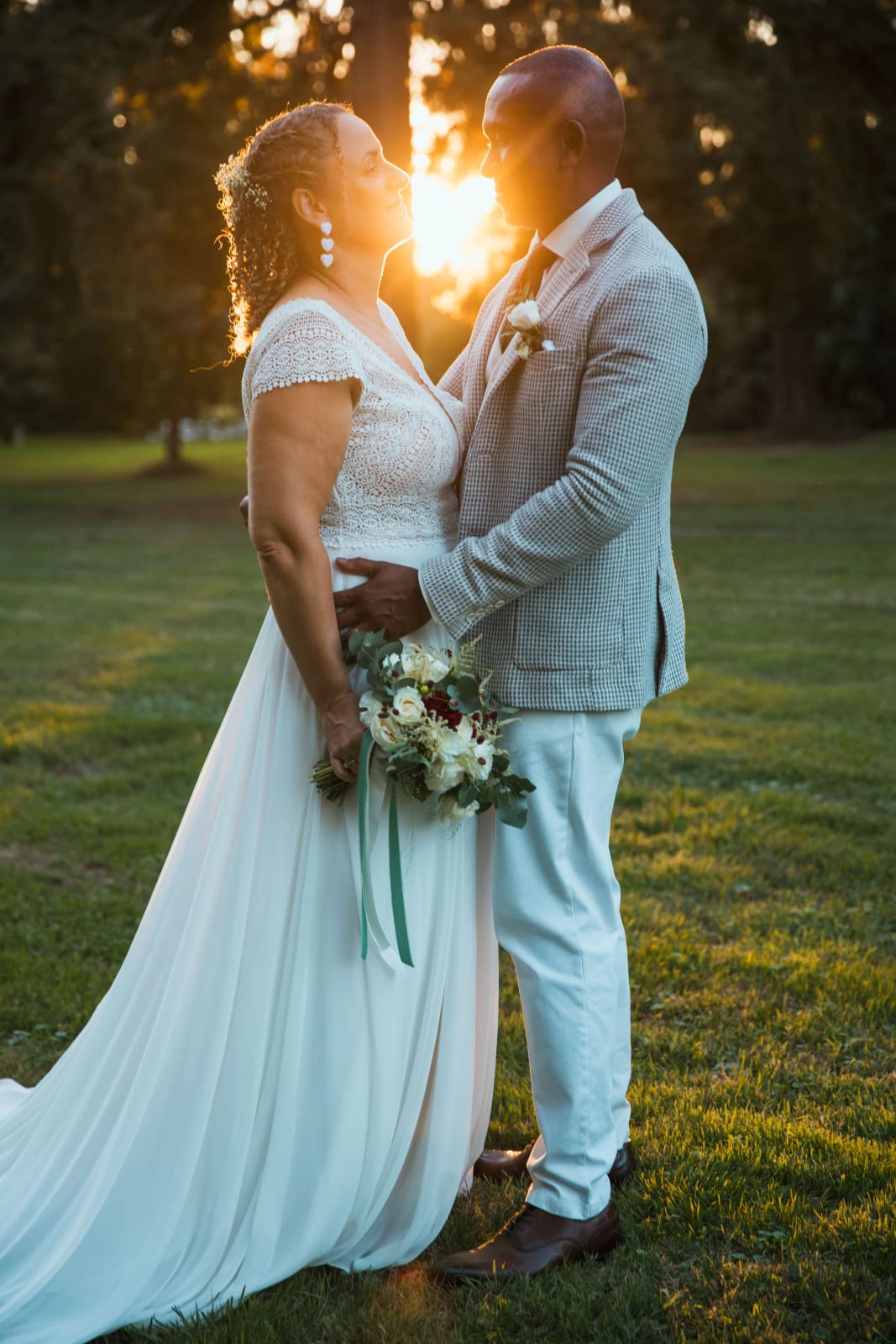 Les mariés face à face dans le parc, le soleil couchant entre leurs deux visages, mariage au Château de la Houssoye, par Jean-Baptiste Argyre (Jaysphotography)