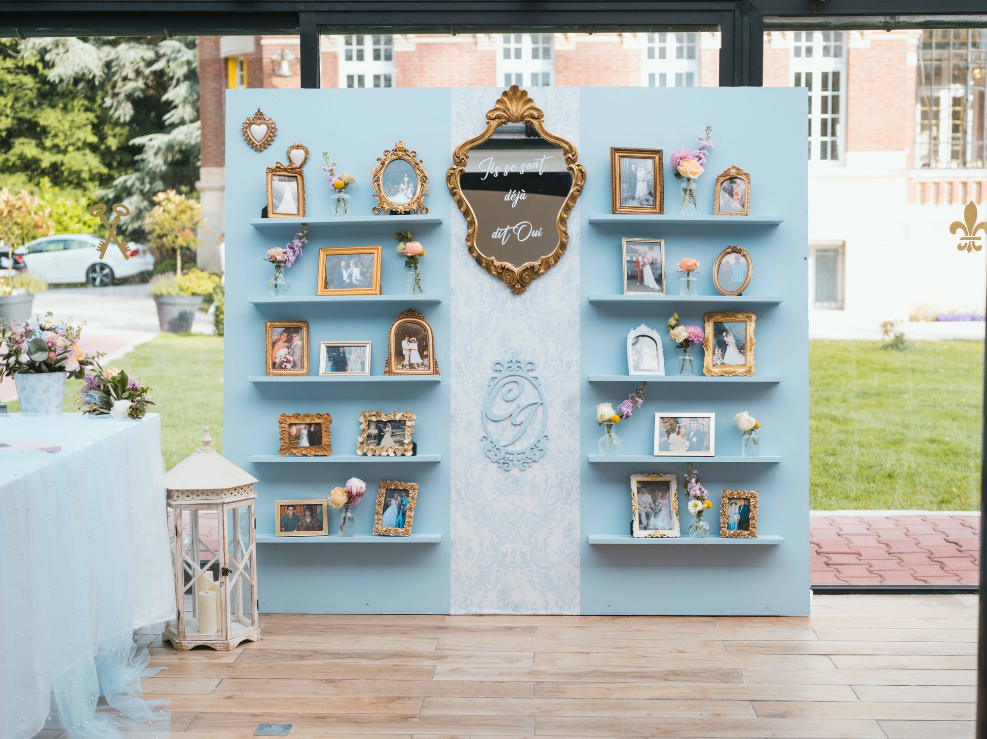 Le décor de cadres dorés et photos de famille sous la verrière du château, mariage au Château de Moliens, par Jean-Baptiste Argyre (Jaysphotography)