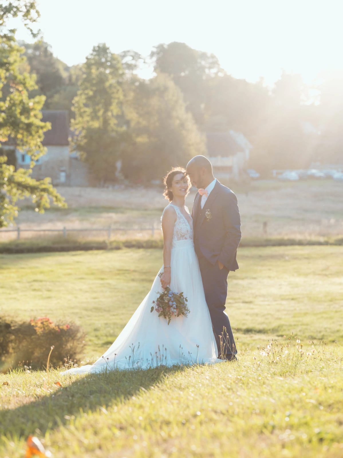 Les mariés sur la pelouse du parc en plein contre-jour doré de fin d'après-midi, mariage au Château de Reilly, par Jean-Baptiste Argyre (Jaysphotography)