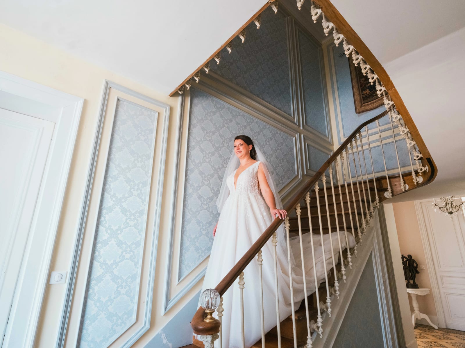 Pauline descendant le grand escalier du Château des Granges en robe de mariée, mariage au Château des Granges, par Jean-Baptiste Argyre (Jaysphotography)