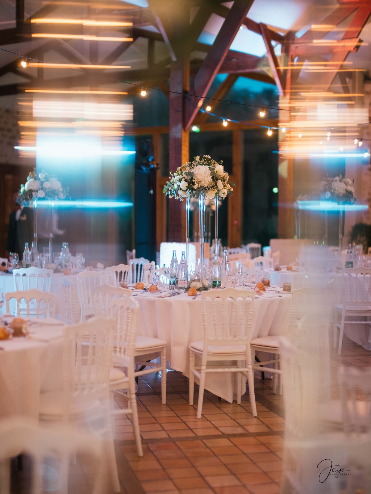 Salle de réception dressée vide, tables blanches et décoration florale, mariage au Domaine de Brunel, par Jean-Baptiste Argyre (Jaysphotography)