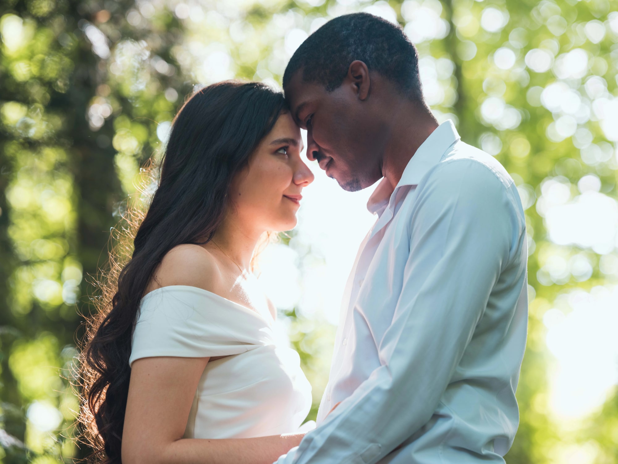 Portrait rapproché du couple dans la lumière filtrée des arbres, mariage au Château de Lamorlaye, par Jean-Baptiste Argyre (Jaysphotography)