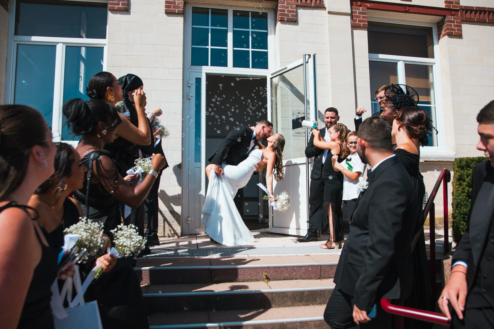 Wendy et Daniel face à l'officier lors de la cérémonie civile, salle remplie d'invités et téléphones levés en arrière-plan, mariage au Château de Lamorlaye, par Jean-Baptiste Argyre (Jaysphotography)