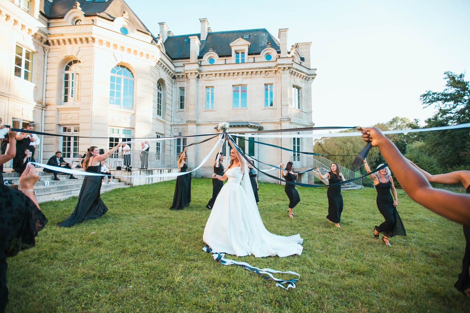 Entrée en salle de Wendy et Daniel sous une machine à brume, lumière dramatique blanche, silhouettes du couple se détachant dans la vapeur, mariage au Château de Lamorlaye, par Jean-Baptiste Argyre (Jaysphotography)